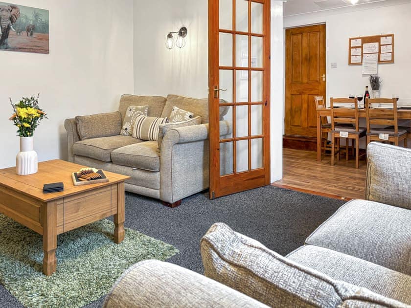 Comfortable living room with an open fireplace | Lavender Cottage, Keswick