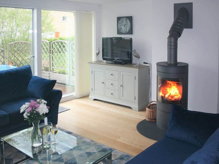 Stylish living space with wood burning stove  | Chestnut Lodge, Somerford Keynes