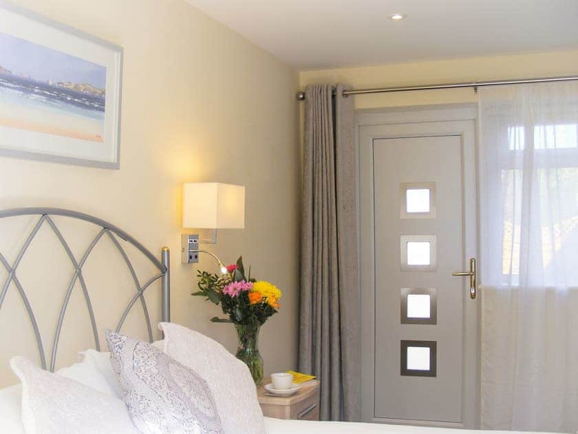 Master bedroom with access to secluded rear garden | Chynoweth, St Merryn, near Padstow