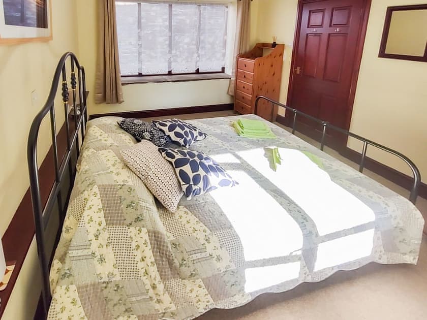 The front bedroom with large window for plenty of light during the day. Well insulated and darkening curtains for a comfortable sleep | Penybont Barn, Llangorse