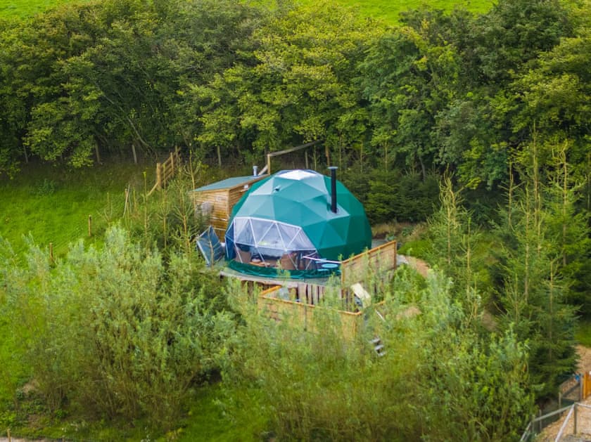Glamping pod surrounded by woodlands.