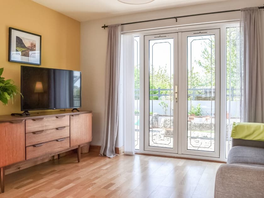 Living area with views over rear patio areas | Pippin Howe, Seaton