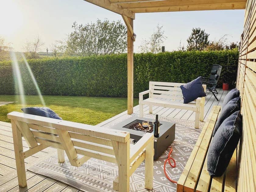 Outdoor area with gas fire pit | Llwyn Ysgaw, Cemaes