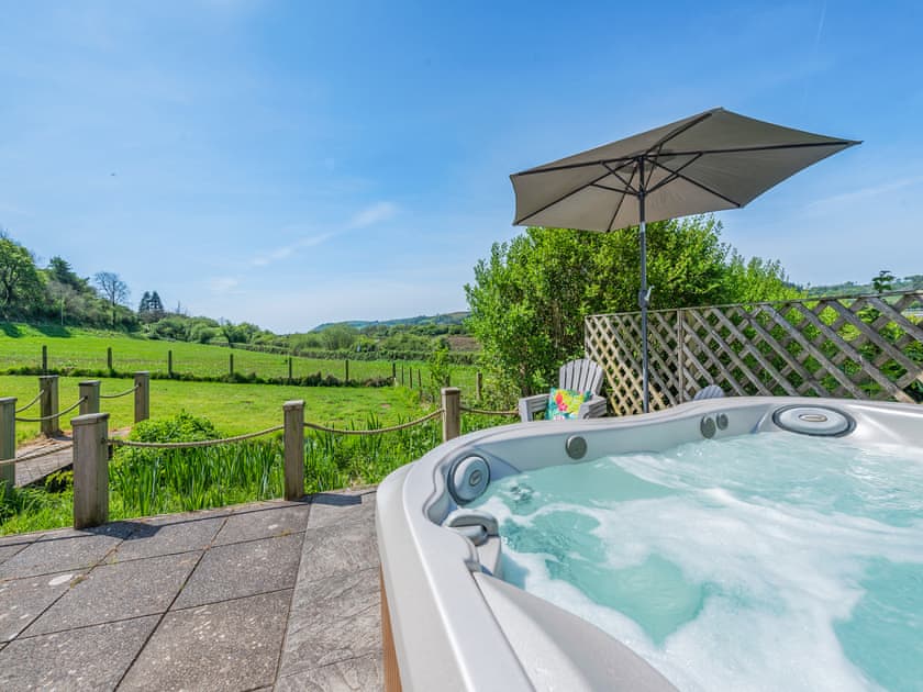 Delightful patio area with hot tub | Bronyn Cottage - Bronyn Farm, Ferryside, near Carmarthen