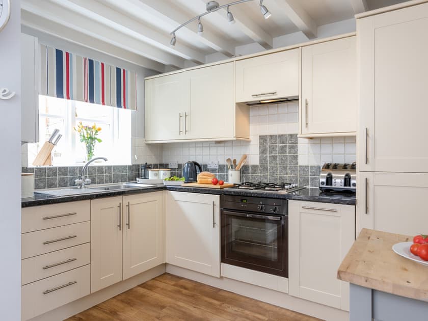 Kitchen with intergated dishwasher, fridge freezer and washing machine | Endeavour Cottage, Whitby