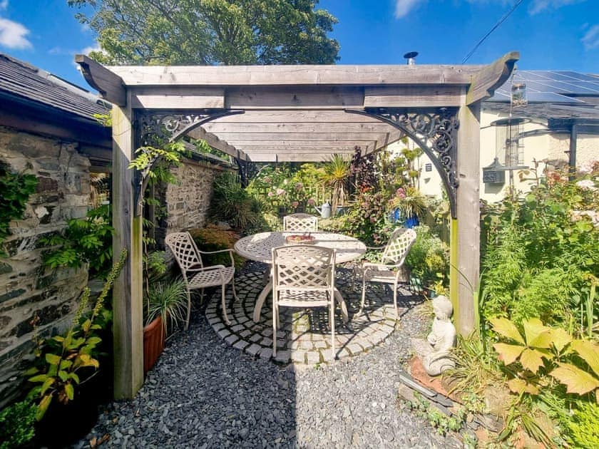Lovely sunny sitting out area underneath the pergola | Stonecroft Cottage - Wreaks End Farm, Broughton-in-Furness