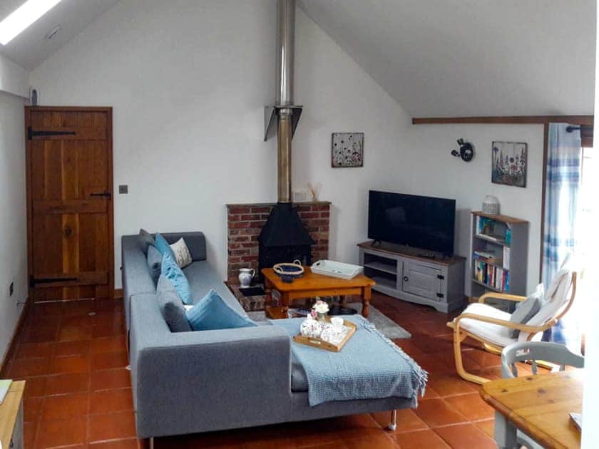 Delightful living room with cosy wood burner | Meadow Barn, East Burton, near Wool