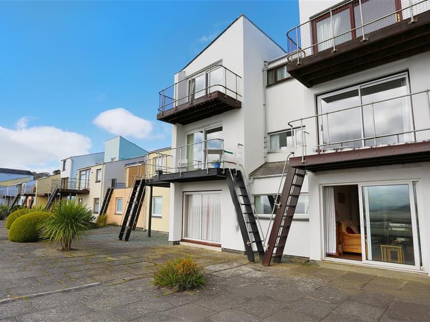 Exterior showing open living room patio doors | Estuary Flat With Views, Porthmadog