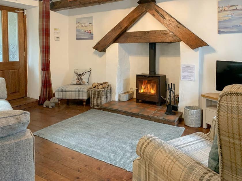 Snug lounge  with wood burner | Keepers Cottage, Red Wharf Bay