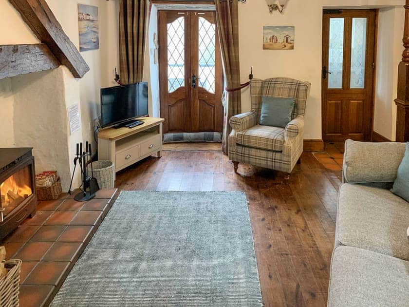 Snug lounge  with wood burner | Keepers Cottage, Red Wharf Bay
