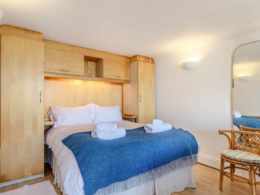 Comfortable double bed with built-in wardrobes for ample storage  | Studio Sea Urchin, Carbis Bay, near St Ives