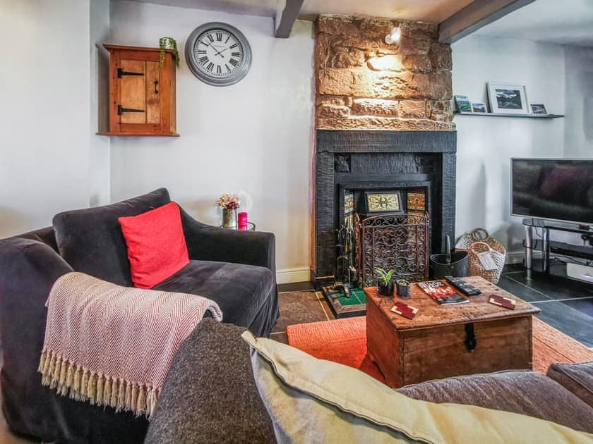 Comfortable seating in living room area with a large 3 seater sofa plus additional velvet love seat armchair. | Mill Cottage, Gosforth