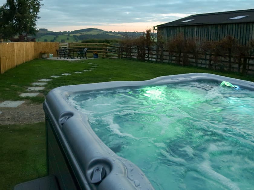 Hot tub at night | Ysgubor Hir, Trefeglwys, near Llanidloes