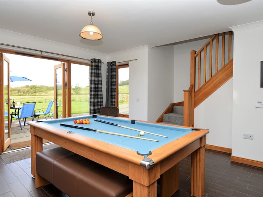 Dining area with table converted to a games table | Kennacraig Lodge, Tarbert