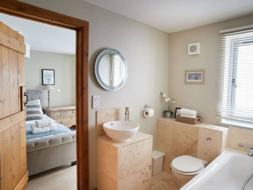 Downstairs Jack and Jill bathroom with connecting door to Master bedroom | The Strawhouse - Manor Mews, Tattersett, near Fakenham
