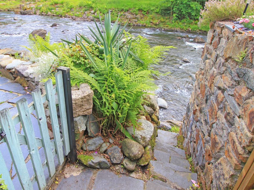 The shared steps that leads down from the patio area to the river itself | Riverside Cottage Beddgelert, Beddgelert