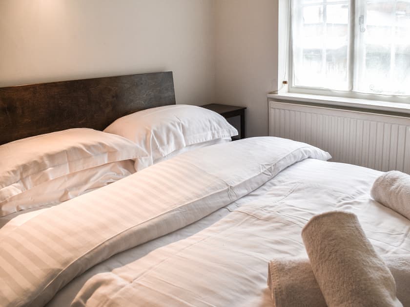 Double bedroom with built in wardrobe, hairdryer and iron. View to quiet residential gardens. | Tudor Cottage, Canterbury
