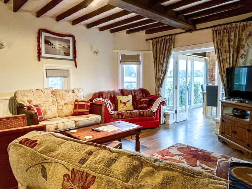 Charming living room with exposed wood beams | Keepers Cottage, Cefn, near St Asaph