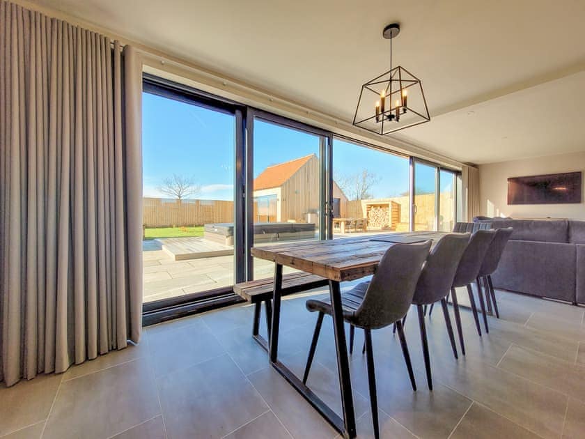 Dining area, bifold doors to garden | Eastgate Barn - Ashlin Farm Barns, Dunholme, near Lincoln
