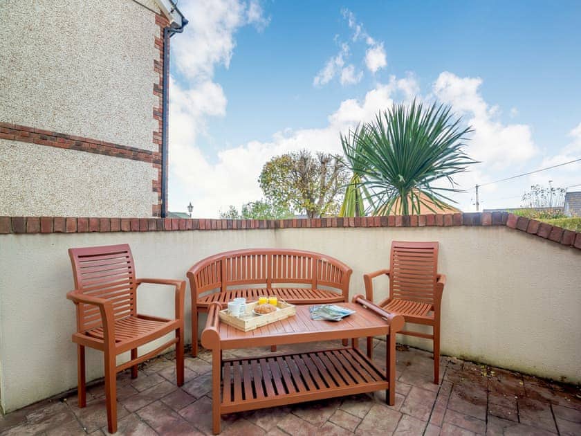Sitting-out-area | Manawydan Cottage - Bryn Awel Caravan Park, Pentraeth
