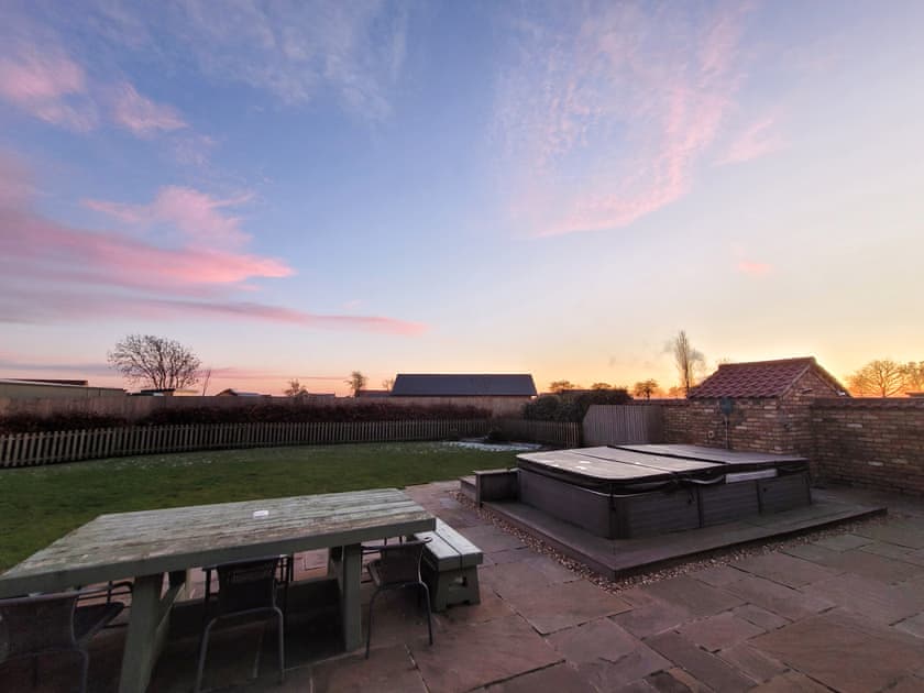 Hot tub and garden sunset view | Wild Cherry Barn - Ashlin Farm Barns, Dunholme, near Lincoln