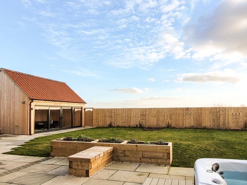 Garden view with hot tub | Rowan House - Ashlin Farm Barns, Dunholme, near Lincoln