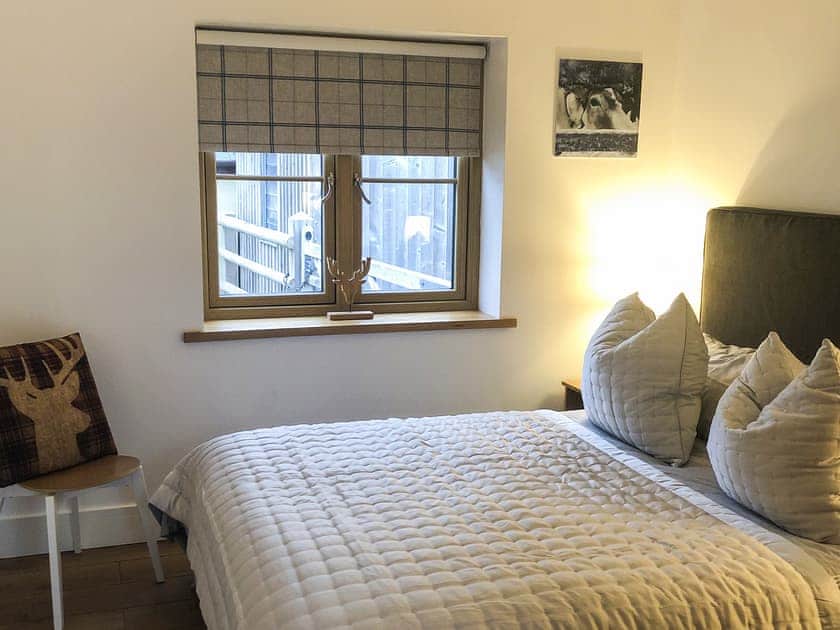 Kingsize bedroom with 32 inch smart TV, situated next to the shower room | Manor Lodge Stables, Wiston, near Haverfordwest