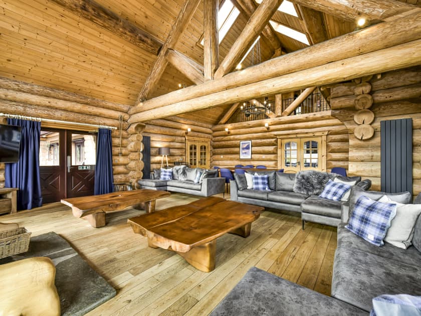 The lounge with French windows over looking the hills | Mountain Bear Lodge, Nethy Bridge, near Aviemore