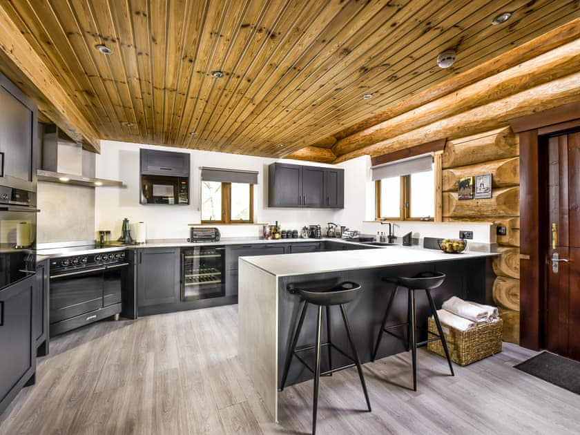 Large kitchen with breakfast bar | Mountain Bear Lodge, Nethy Bridge, near Aviemore