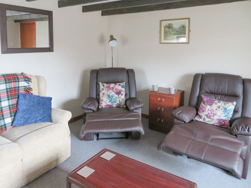 Spacious living room with comfortable recliners | Breacwell Cottage, Migdale, near Dornoch