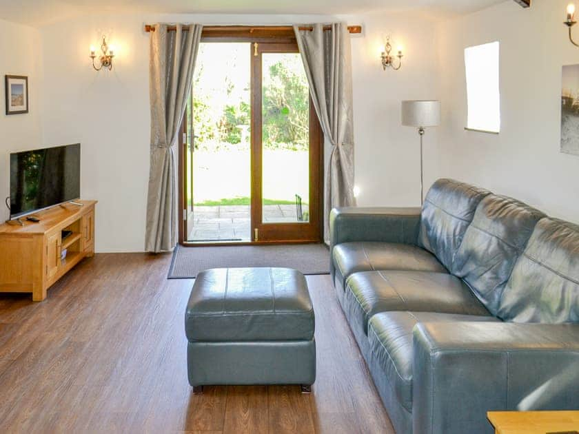 Comfortable living area with French door leading to garden | Sunrise - Little Crugwallins, St Austell