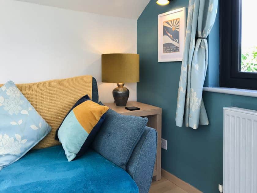 Lounge area; comfy sofa and soft lighting | Little Fursdon Apartment, Liskeard