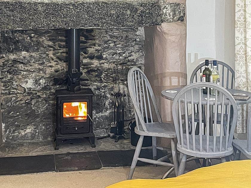 Dining area with log fire | Tryfan - Red Dragon Cottages, Beddgelert