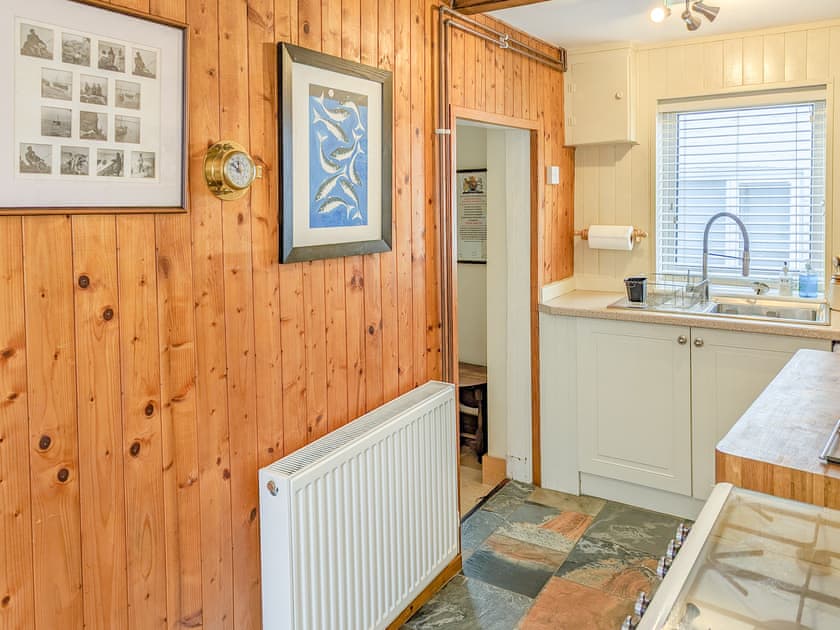 Kitchen with cosy ship’s galley feel | Trinity Cottage, Wells-next-the-Sea