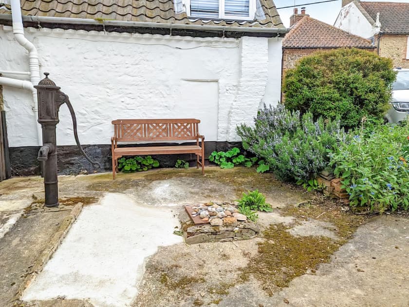 Outdoor area with original well pump  | Trinity Cottage, Wells-next-the-Sea