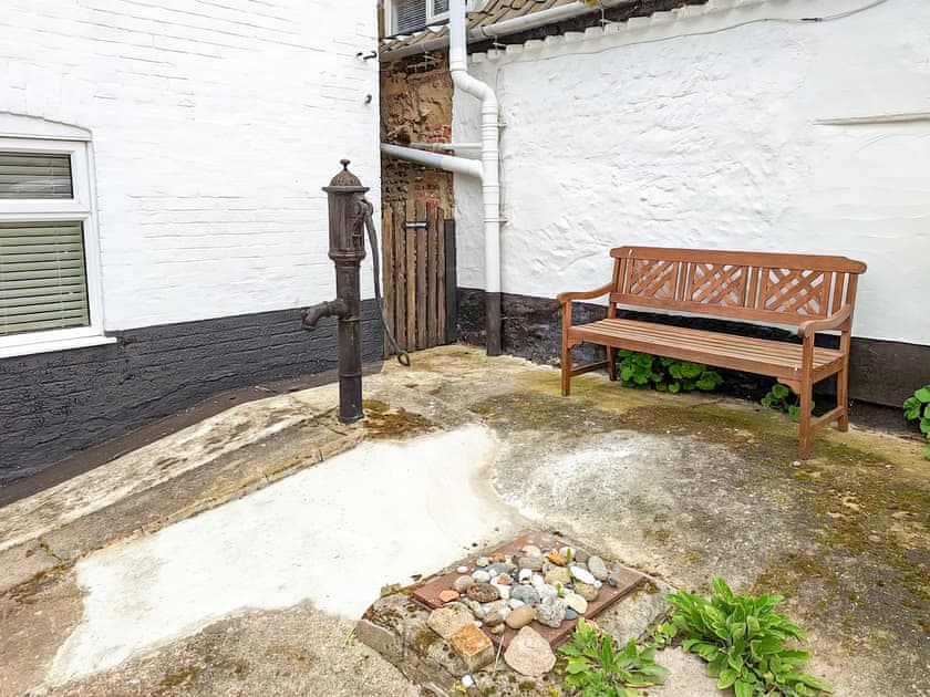 South facing seating area at the rear of the property | Trinity Cottage, Wells-next-the-Sea