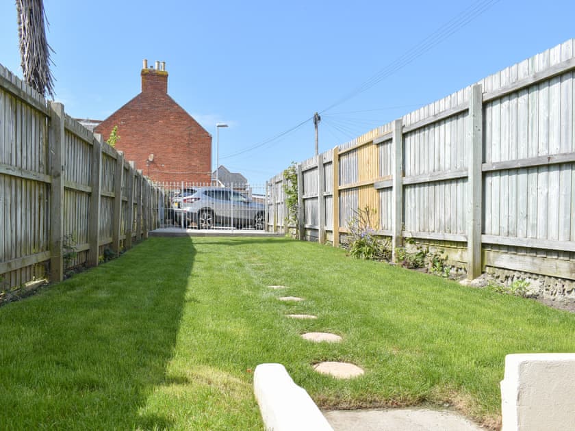 Garden with parking area at far end | Newstead Cottage, Weymouth