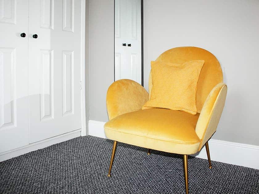 Upstairs double with comfortable armchair, perfect for relaxing with a book or your morning coffee | Captain’s Cottage, Shanklin