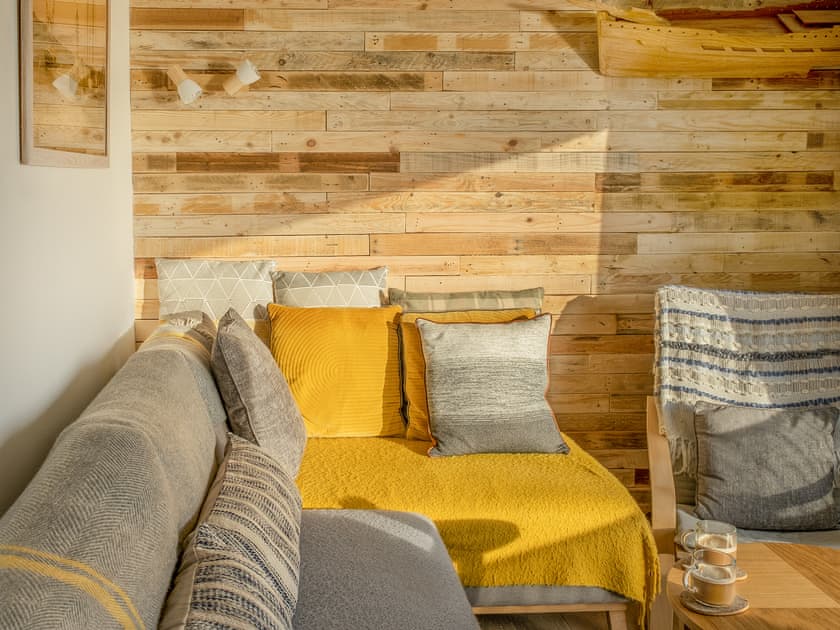 The large corner sofa is very comfortable. The recycled pallet planks, add charm and warmth | Old Quay, Newlyn