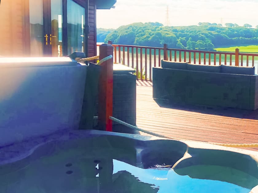 Hot tub with river view | Badger Lodge, Burton