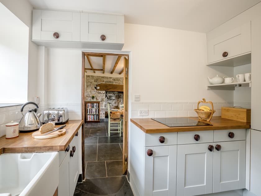 The kitchen is compact, but does have a full size fridge/freezer, 4 ring induction hob, oven/grill, microwave, dishwasher and washing machine | Derwen Deg Fawr, Llanfair Dyffryn, near Llangollen