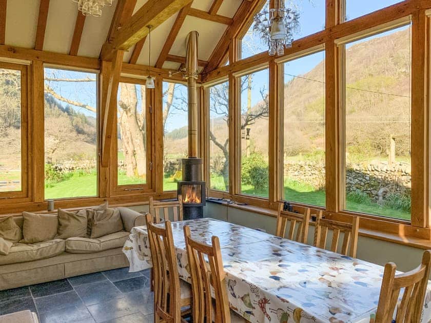Light and airy dining area within conservatory | Dol Y Clochydd, Llanfachreth, near Dolgellau