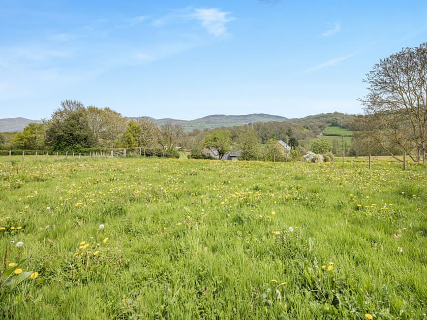 View from the top of the guest field, looking over the cottage roof | Derwen Deg Fawr, Llanfair Dyffryn, near Llangollen