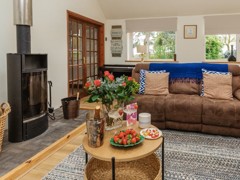 Light and airyliving room with patio doors leading to garden | Woodlands, Langford Budville, near Wellington