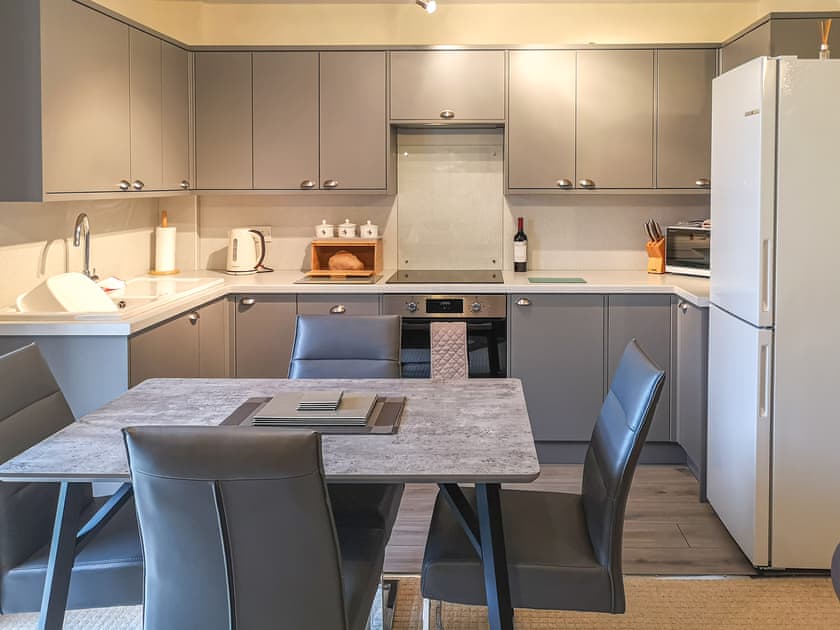 Kitchen/diner with bottle of wine and homemade bread  | Cysgod Y Coed, Llanbedr