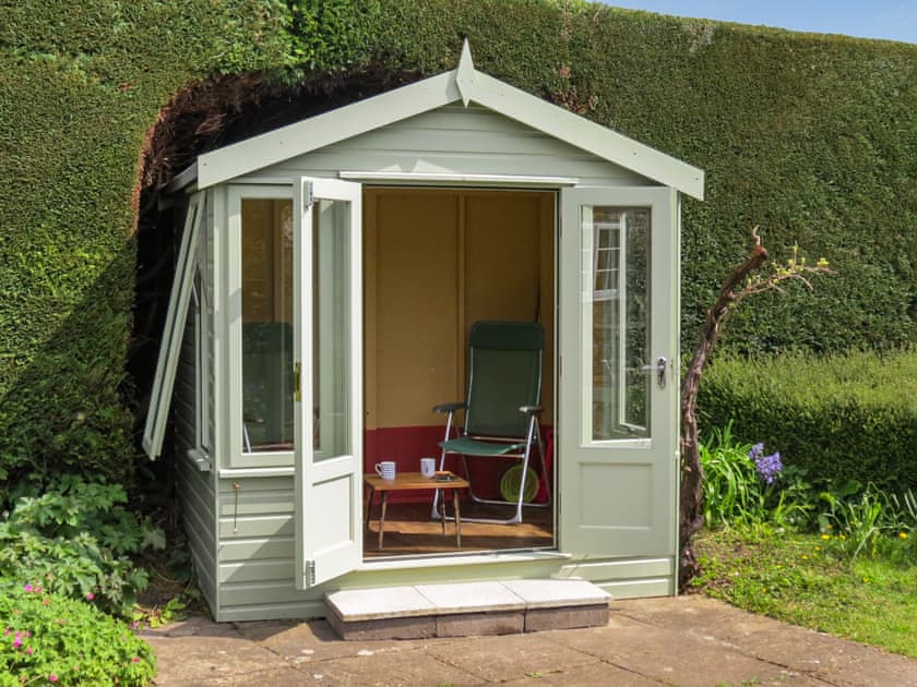 Enjoy the garden from the cosy summerhouse | The Old Post Office, Lower Bockhampton