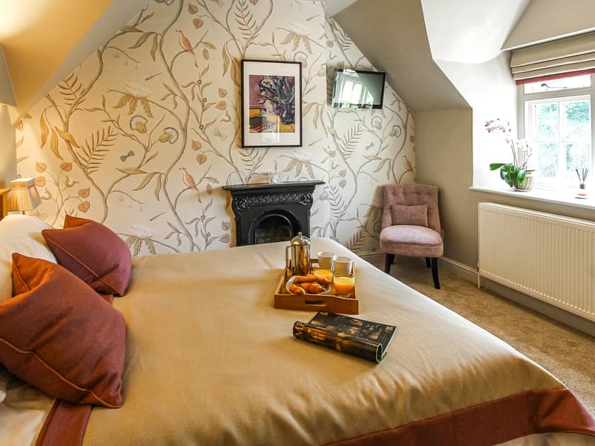 Bedroom with original feature fireplace | Pond View Cottage, Brantingham, near Beverley