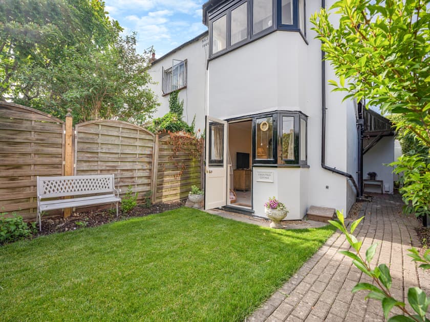 Garden with seating, leading straight into the open plan front room and dining area | Greenfield Cottage 1866, Worthing
