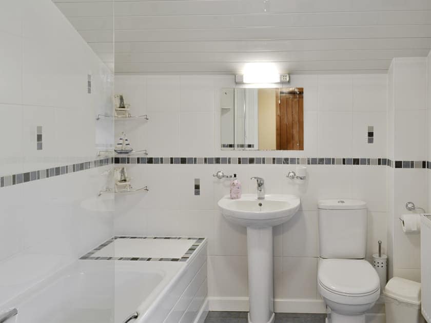 Downstairs family bathroom with shower over bath | Beudy Hen - Beudy Hen and Ysgubor, Llanfair, near Harlech