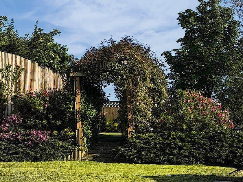 Garden leading to private seating area | The Dunes, Bridgend